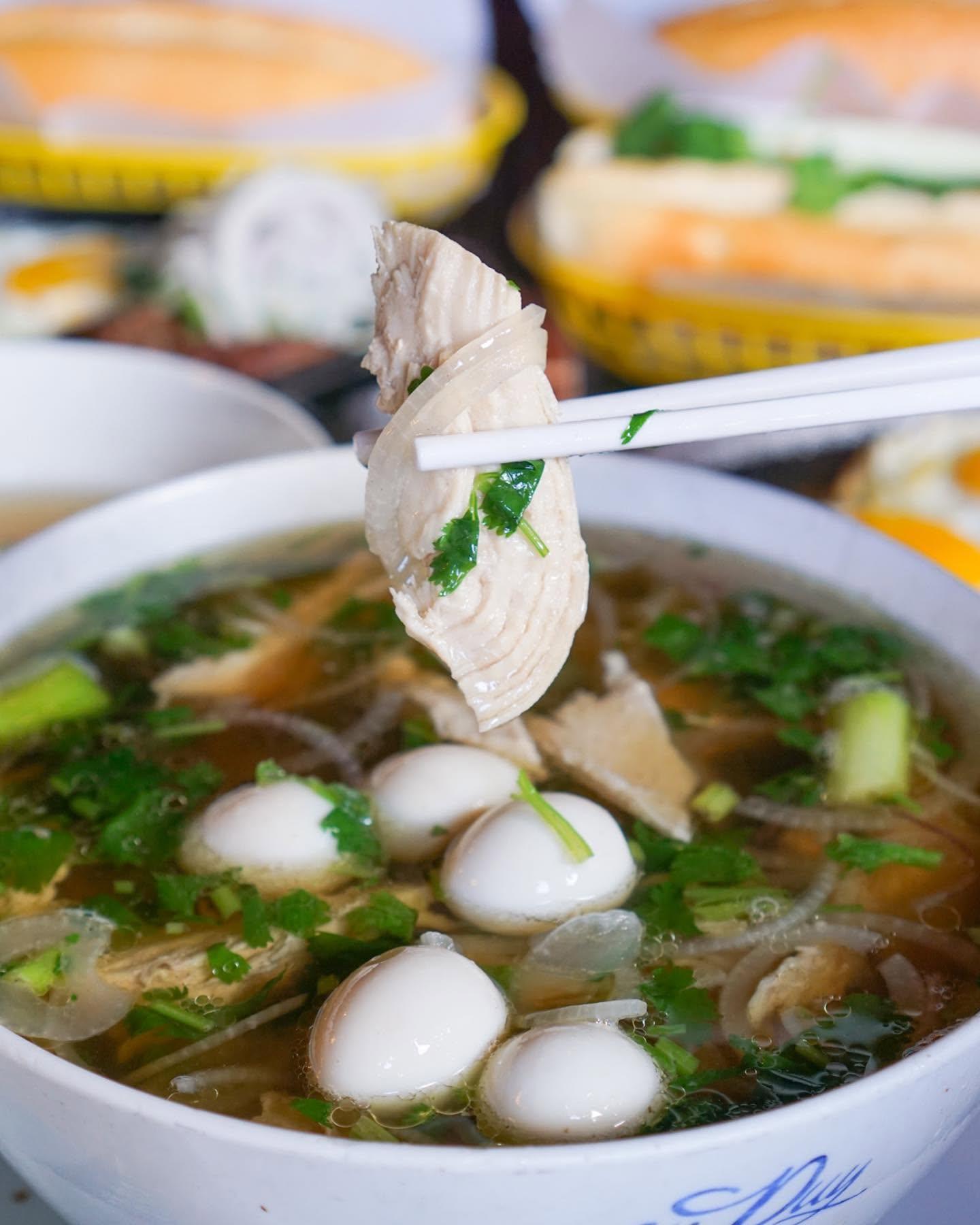 Chicken pho with quail eggs and herbs